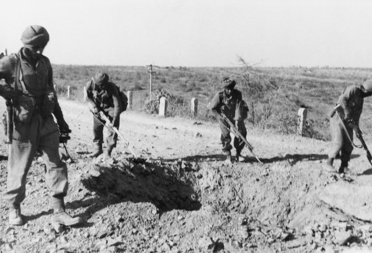Indiske soldater søker etter miner langs en grusvei, 1941 av English Photographer